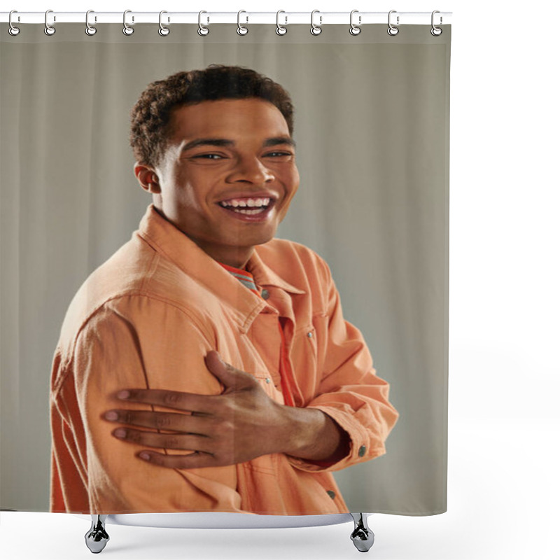 Personality  Cheerful Man In Peach Shirt Standing Against Grey Wall, Showcasing His Impeccable Fashion Sense Shower Curtains