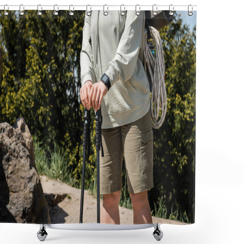 Personality  Cropped View Of Young Female Tourist With Fitness Tracker And Backpack With Climbing Rope Holding Trekking Poles While Standing With Nature At Background, Trekking Through Rugged Terrain Shower Curtains