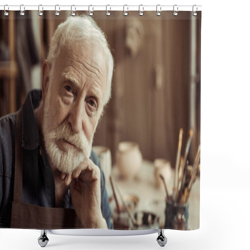 Personality  Portrait Of Senior Potter In Apron Sitting At Table And Looking At Camera Shower Curtains