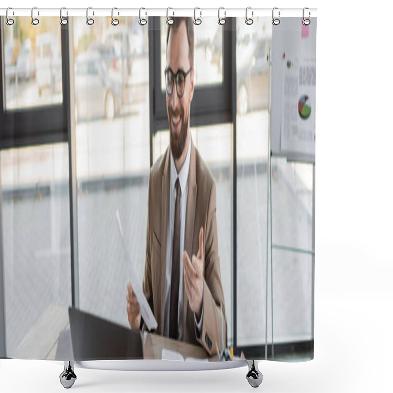 Personality  Happy And Successful Entrepreneur In Stylish Eyeglasses, Beige Blazer And Tie Holding Document And Pointing With Hand During Video Conference On Laptop Near Notebooks In Modern Office, Banner Shower Curtains