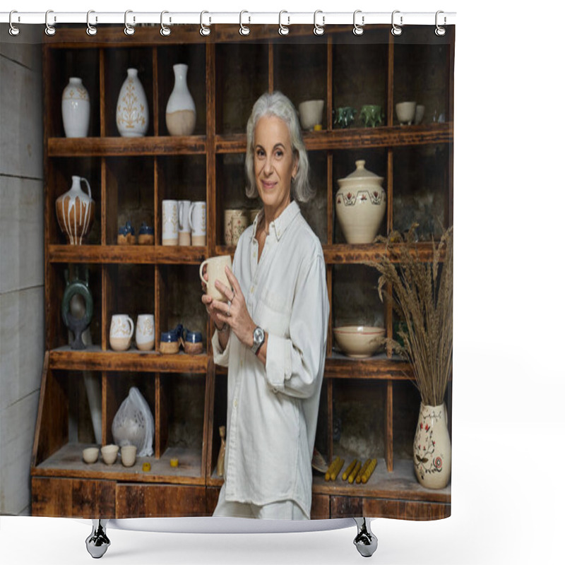 Personality  The Mature Woman Smiles While Showcasing A Beautiful Handmade Cup In Her Ceramic Workshop. Shower Curtains