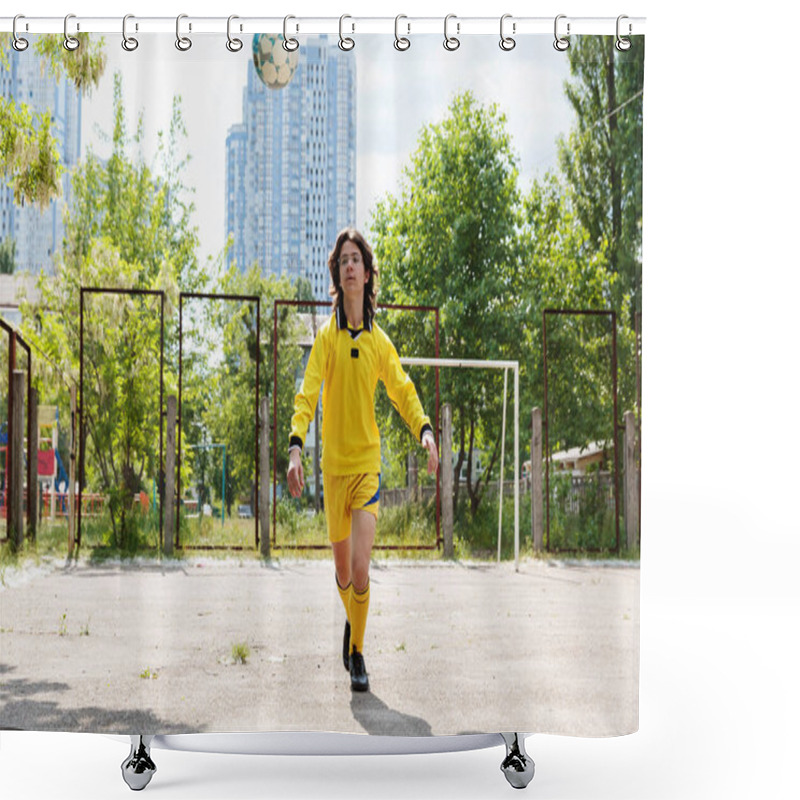 Personality  A Young Footballer In A Yellow Uniform Juggles The Ball On An Outdoor Playground, Improving His Control. Shower Curtains