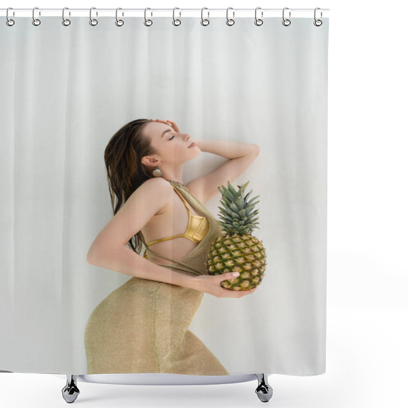 Personality  Side View Of Smiling Woman In Golden Swimwear And Dress Holding Ripe Pineapple Near While Wall  Shower Curtains