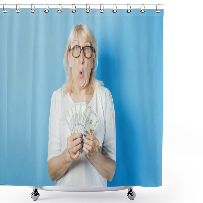 Personality  Old Lady With Glasses Holds Money In Her Hands Against A Blue Background. Concept Of Wealth, Winnings, Savings, Lottery, Loan Shower Curtains