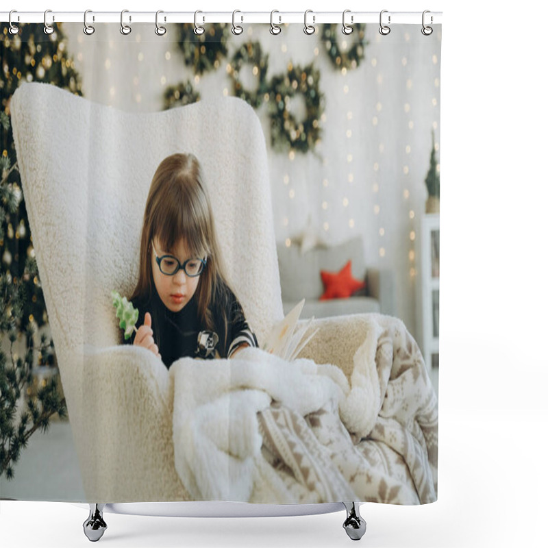 Personality  A Little Girl With Down Syndrome Reads A Book While Sitting In A White Chair On Christmas Eve. Raising A Child With Down Syndrome. Shower Curtains