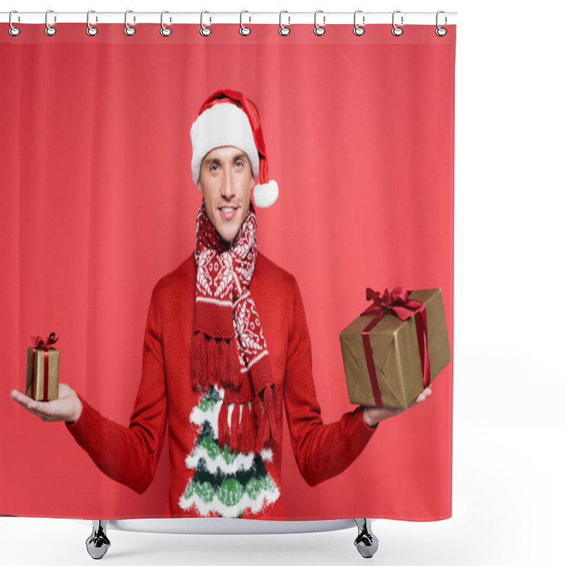 Personality  Smiling Man In Santa Hat Holding Gift Boxes And Looking At Camera On Red Background Shower Curtains