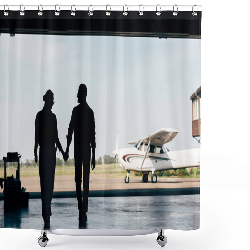 Personality  Rear View Of Silhouettes Of Young Couple Holding Hands And Walking In Hangar Near Airplane  Shower Curtains