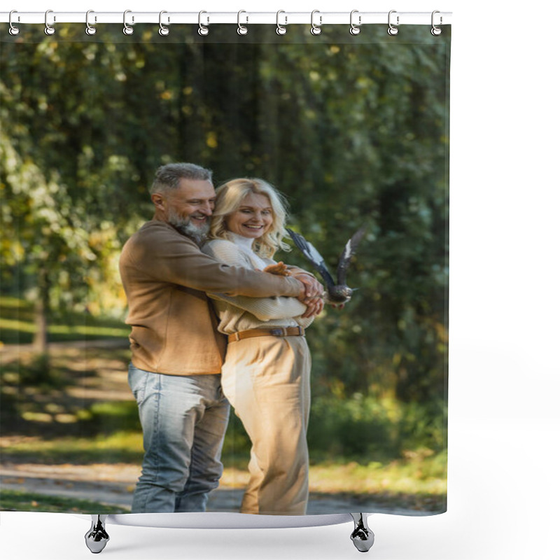 Personality  Pleased Middle Aged Man Hugging Blonde Wife Near Flying Pigeon In Park  Shower Curtains