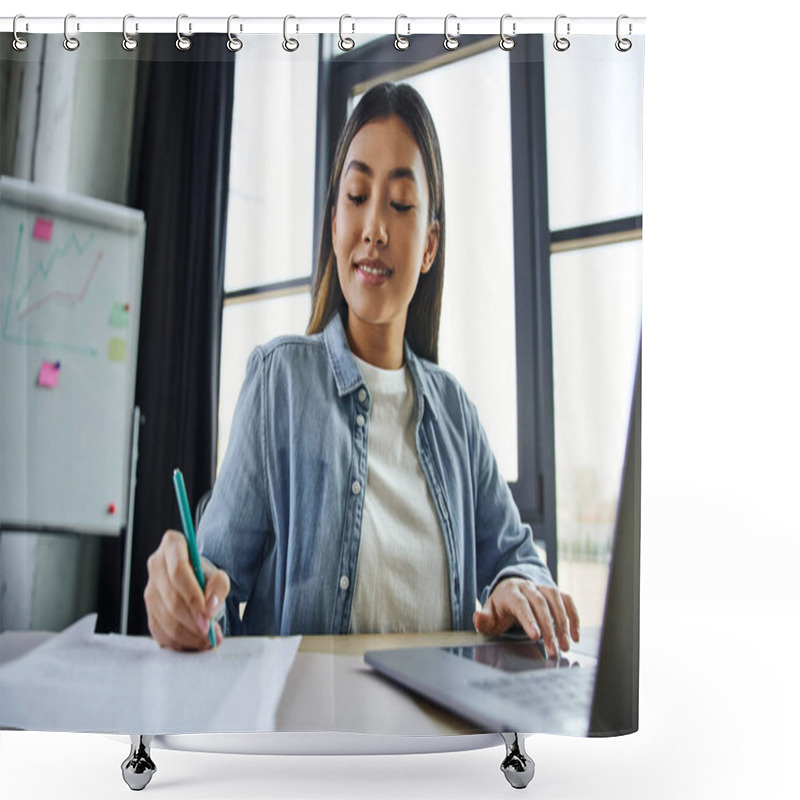 Personality  Smiling Asian Woman With Brunette Hair, In Blue Denim Shirt Working On Laptop And Writing On Documents Near Flip Chart On Blurred Background In Contemporary Office, Successful Entrepreneurship Shower Curtains