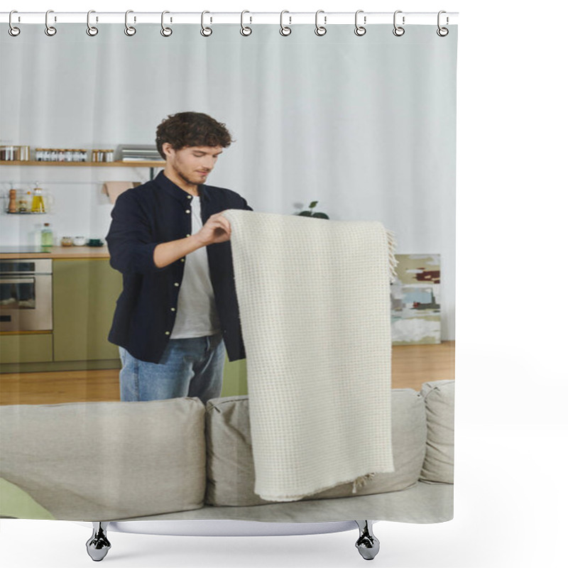 Personality  A Handsome Young Man Tidies Up A Blanket In His Contemporary Living Space, Showcasing His Style. Shower Curtains