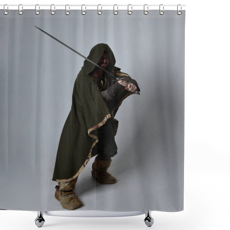 Personality  Full Length  Portrait Of  Young Handsome Man  Wearing  Medieval Celtic Adventurer Costume With Hooded Cloak, Holding Sword, Isolated On Studio Background. Shower Curtains