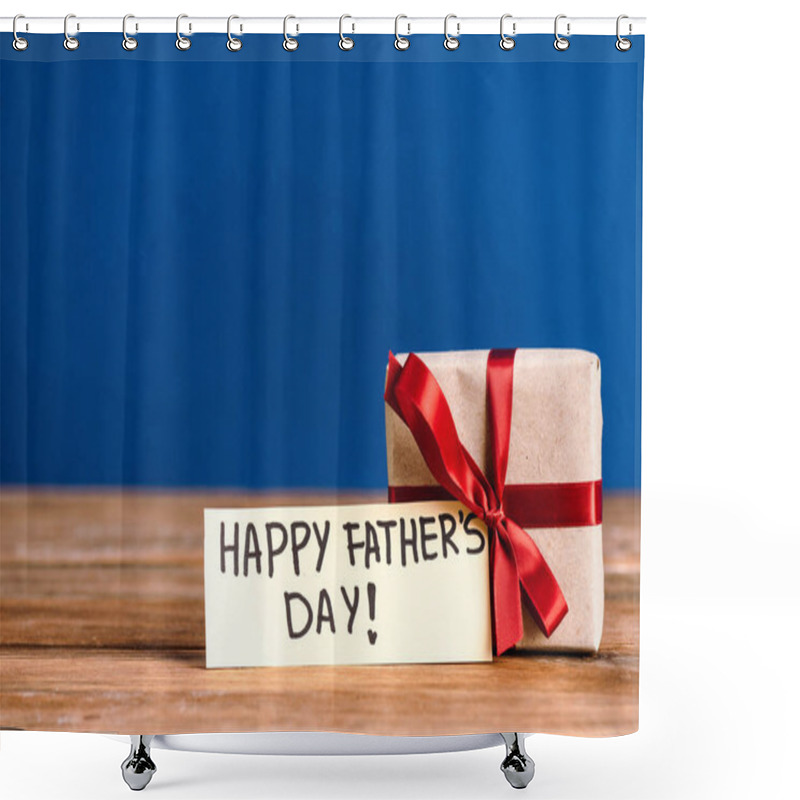 Personality  Selective Focus Of Greeting Card With Lettering Happy Fathers Day And Gift Box With Red Bow On Wooden Table Isolated On Blue Shower Curtains