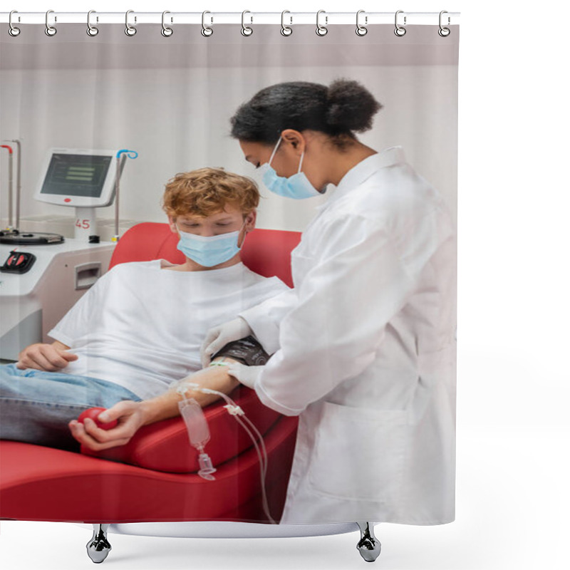 Personality  Multiracial Doctor In White Uniform And Medical Mask Sticking Band-aid On Arm Of Redhead Man With Transfusion Set Sitting On Medical Chair Near Automated Equipment In Blood Donation Center Shower Curtains