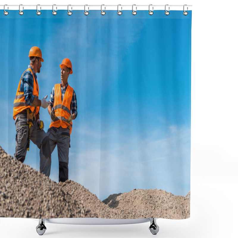 Personality  Selective Focus Of Coworkers In Orange Helmets Standing On Stones Against Sky  Shower Curtains