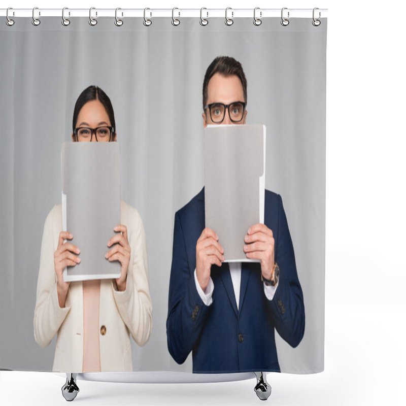 Personality  Interracial Couple Of Businesspeople In Eyeglasses Obscuring Faces With Folders Isolated On Grey Shower Curtains