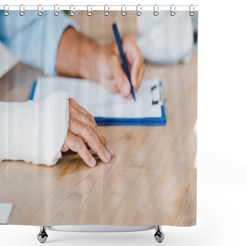 Personality  Cropped View Of Injured Man With Gypsum Bandage On Broken Arm Writing On Clipboard  Shower Curtains