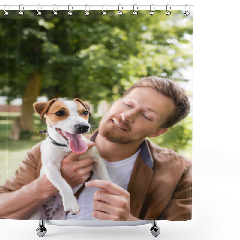 Personality  Young Man Holding White Jack Russell Terrier Dog With Brown Spots On Head In Park Shower Curtains