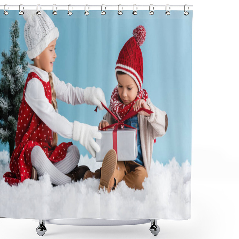 Personality  Children In Hats And Winter Outfit Sitting On Snow And Touching Present Isolated On Blue Shower Curtains