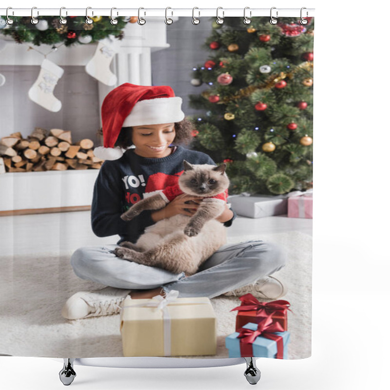 Personality  Cheerful African American Girl Holding Cat While Sitting With Crossed Legs Near Christmas Tree On Blurred Background Shower Curtains