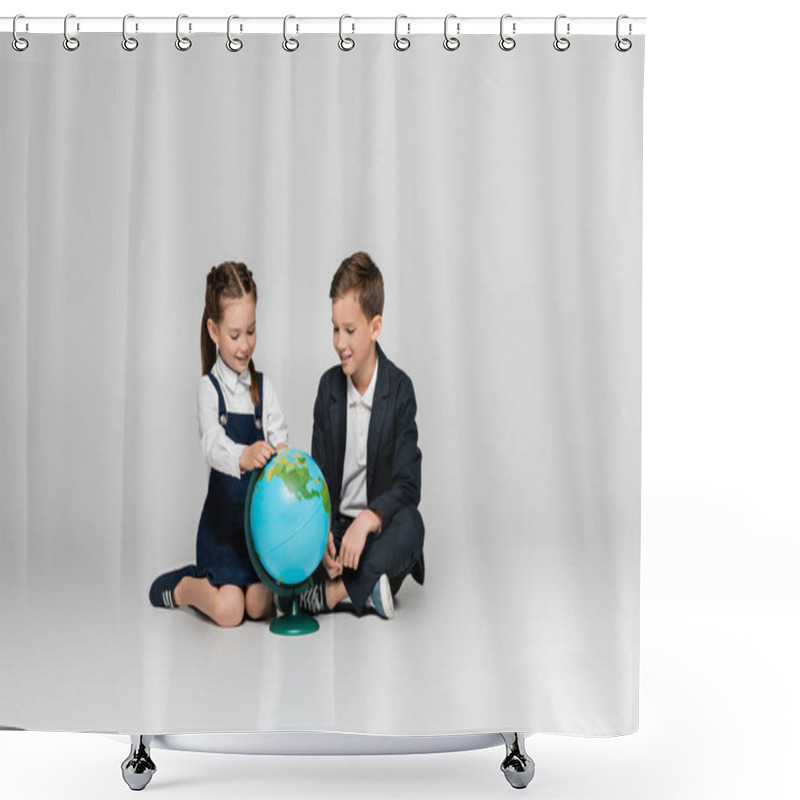 Personality  Happy Schoolgirl And Schoolboy Looking At Globe While Sitting On Grey Shower Curtains