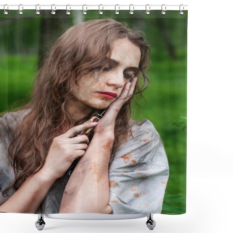 Personality  Beautiful Young Dirty Mad And Manic Looking Girl Wearing Torn Clothes And Smeared With Mud And Dried Blood Touches The Face With A Knife In The Forest. Copy Space. Concept Design. Shower Curtains