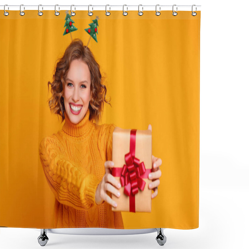 Personality  Happy Young Woman In Sweater And Headband Showing Wrapped Present And Looking At Camera With Smile On Christmas Day Against Yellow Backgroun Shower Curtains