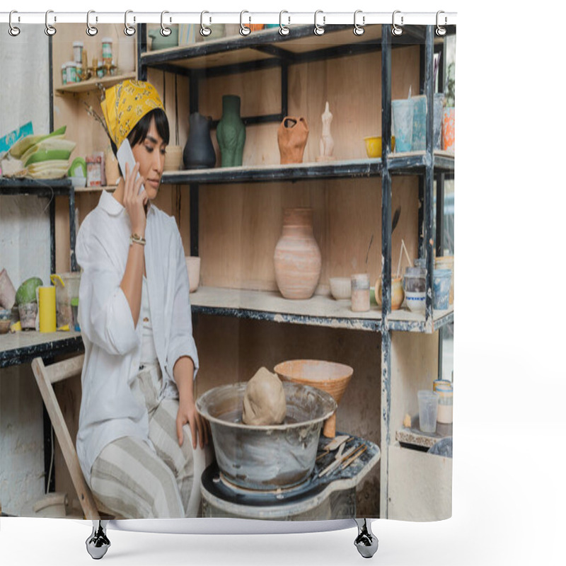 Personality  Young Asian Female Potter In Workwear And Headscarf Talking On Smartphone While Sitting Near Clay On Pottery Wheel And Tools And Working In Pottery Studio, Artisan Crafting Ceramics In Studio Shower Curtains