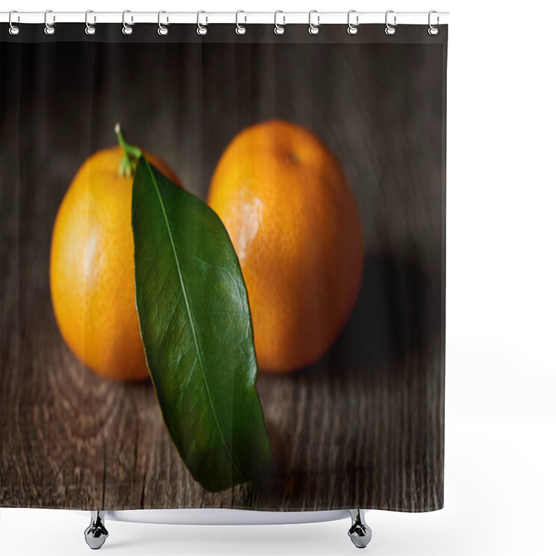 Personality  selective focus of green leaf on organic tasty tangerine on wooden table  shower curtains