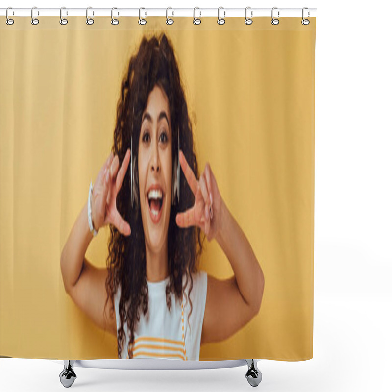 Personality  Panoramic Shot Of Excited Mixed Race Girl In Wireless Headphones Showing Victory Gesture On Yellow Background Shower Curtains