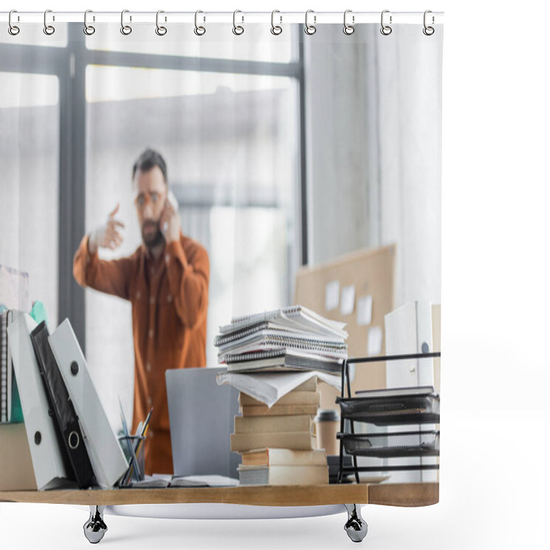 Personality  Selective Focus Of Office Desk With Pile Of Books, Notebooks, Folders And Laptop Near Busy Businessman Gesturing While Talking On Mobile Phone And Solving Problem On Blurred Background Shower Curtains