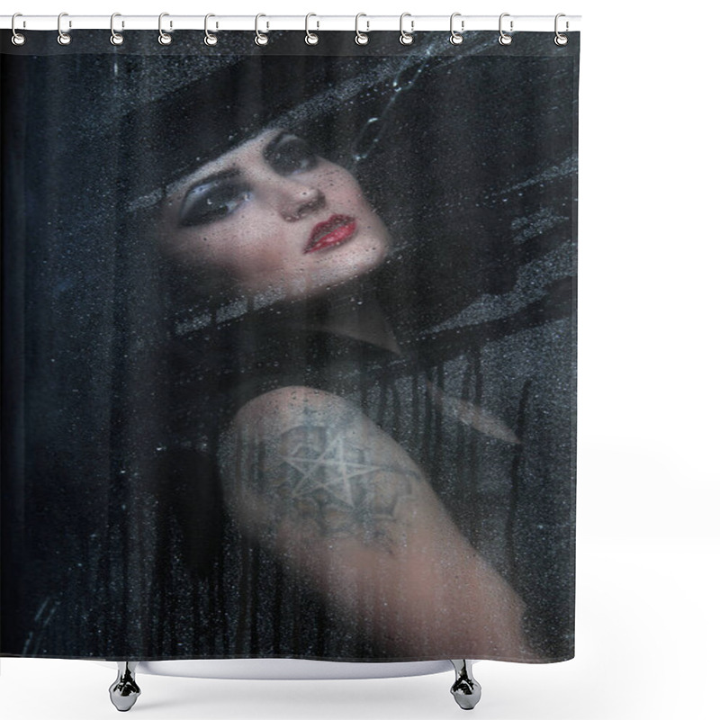 Personality  Portrait Of A Beautiful Angry Brunette With A Tattoo Of A Pentagram Behind Wet Glass After Rain Shower Curtains