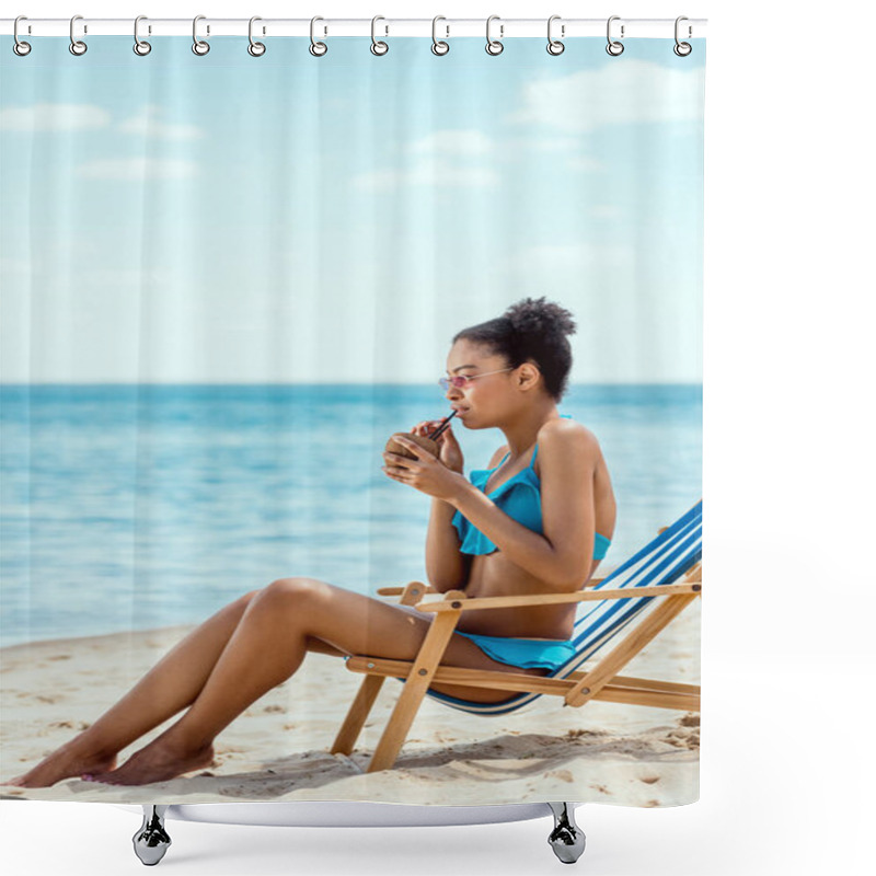 Personality  Young African American Woman In Bikini And Sunglasses Drinking Cocktail In Coconut Shell While Sitting On Deck Chair In Front Of Sea  Shower Curtains