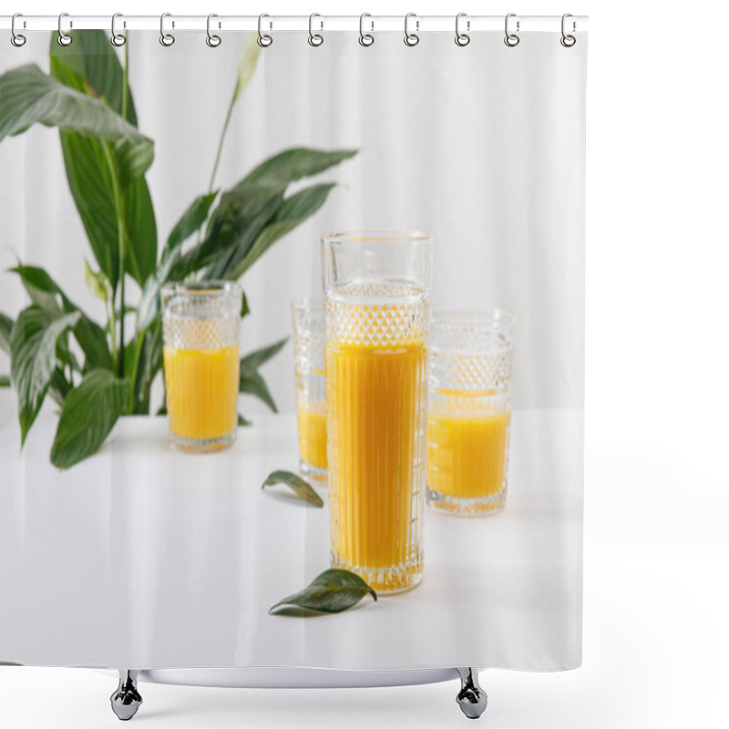 Personality  Selective Focus Of Glasses Of Fresh Delicious Yellow Smoothie On White Surface Near Green Peace Lily Plant Isolated On Grey Shower Curtains