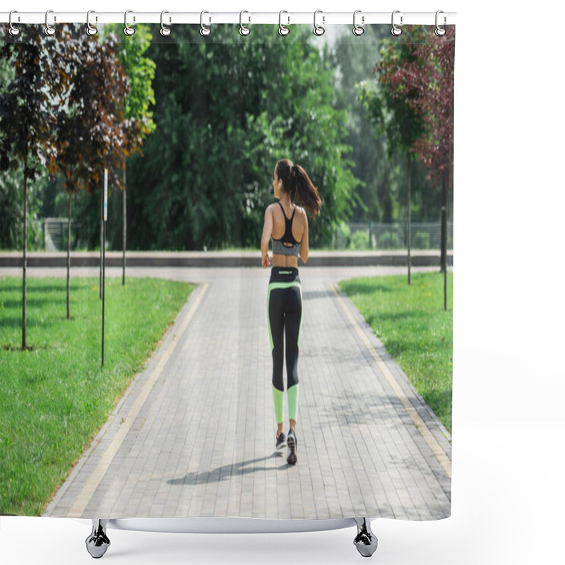 Personality  Back View Of Sportive Woman In Crop Top, Leggings And Wireless Earphones Listening Music While Running In Park Shower Curtains