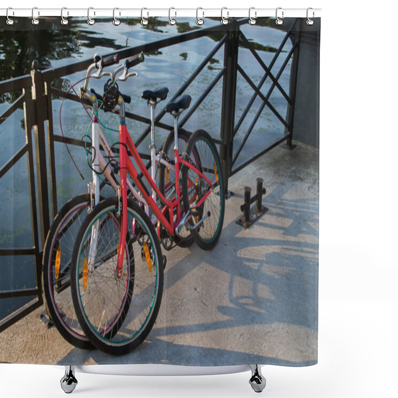 Personality  In The Morning Two Bikes White And Red Of Travelling Together Persons Parked And Locked With Anti-theft Cables To The Fence Street On The Background Of Azure Water In The River Shower Curtains