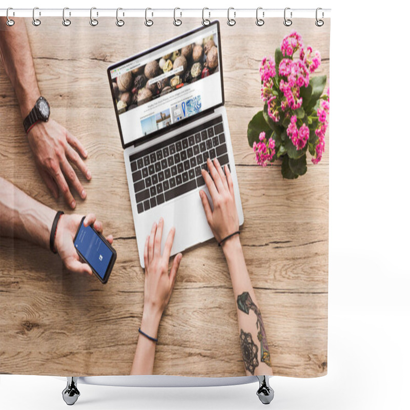 Personality  Cropped Shot Of Man With Smartphone With Facebook Logo In Hand And Woman At Tabletop With Laptop With Depositphotos Website And Kalanchoe Flower Shower Curtains