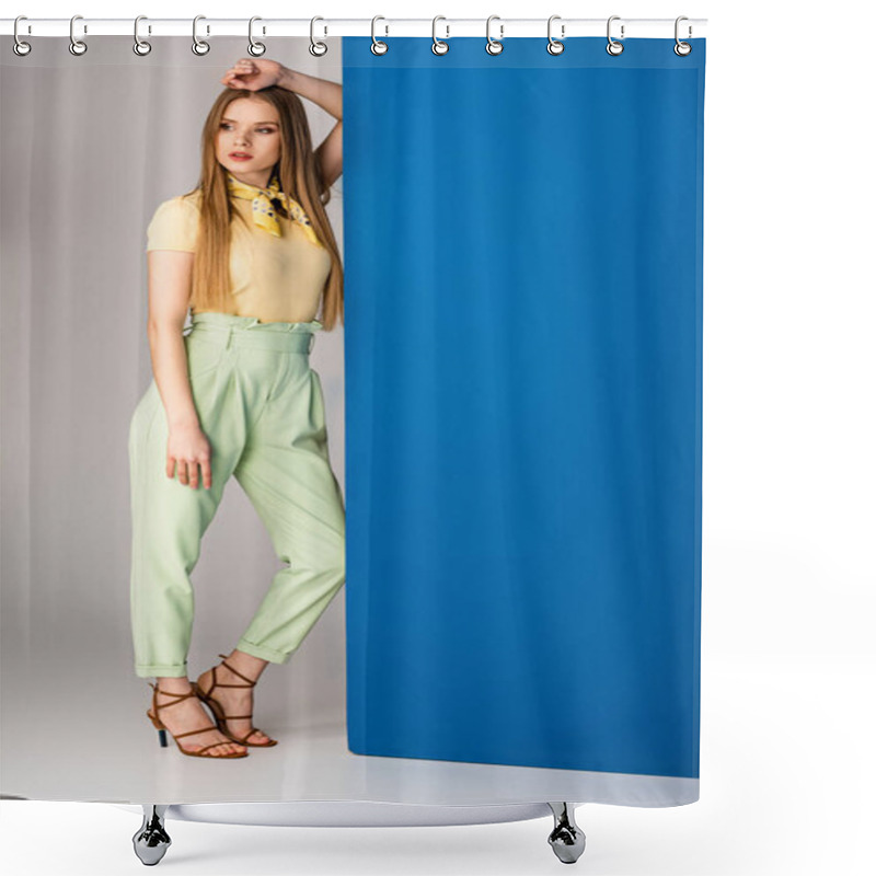 Personality  Fashionable Girl Posing In Green Summer Trousers, Yellow T-shirt And Heeled Sandals On Grey And Blue Shower Curtains