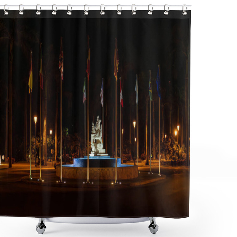 Personality  A Nighttime Scene Showcasing A Statue, Vibrant Flags, And A Blue Fountain, Symbolizing Cultural Pride And Unity. Shower Curtains