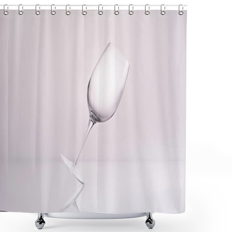 Personality  Empty Inclined Wineglass On Reflective Surface And On White Shower Curtains