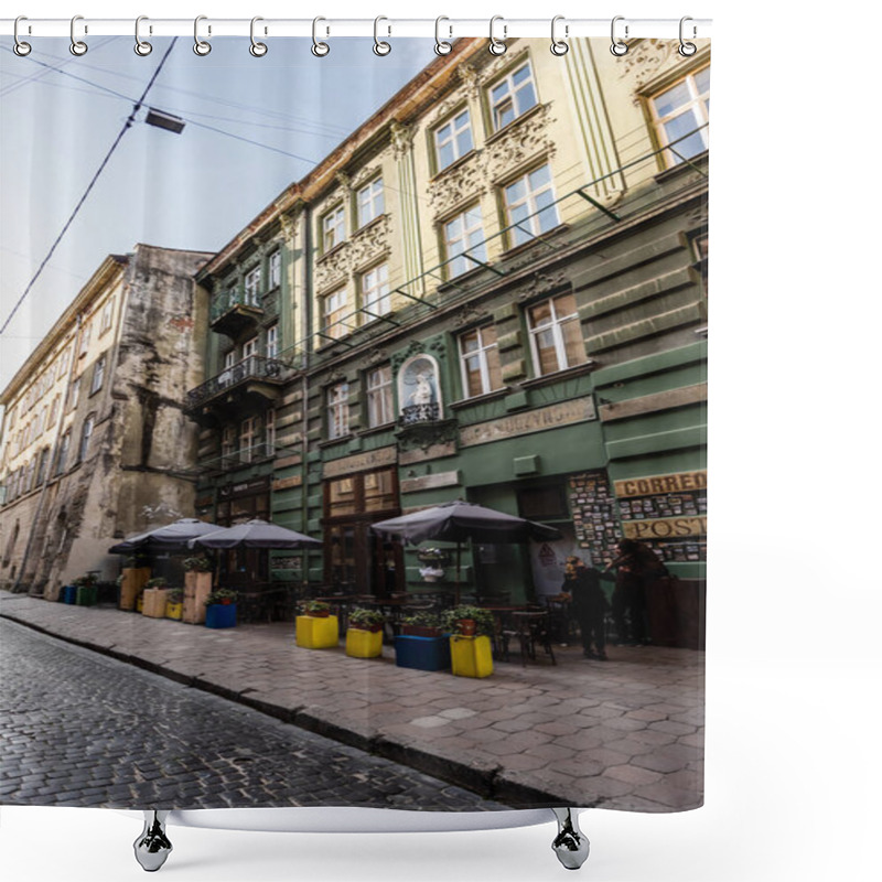 Personality  LVIV, UKRAINE - OCTOBER 23, 2019: Street Cafe With Plants In Flowerpots Near Old House With Latin Lettering  Shower Curtains