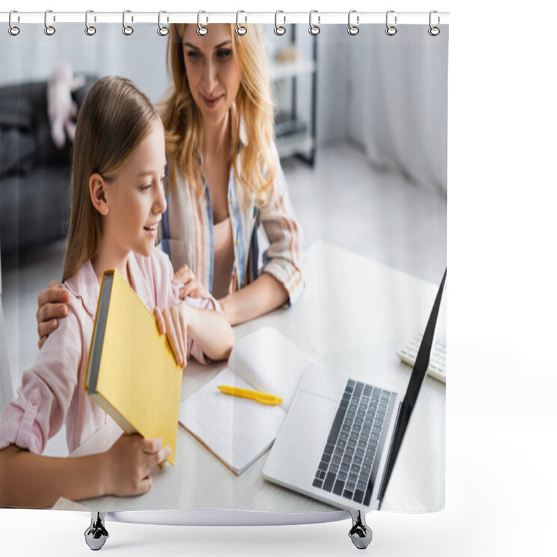 Personality  Selective Focus Of Woman Embracing Smiling Daughter Holding Book Near Laptop And Notebook On Table  Shower Curtains