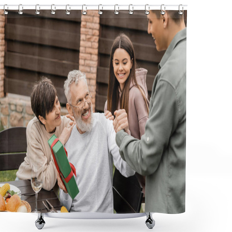 Personality  Cheerful Middle Aged Father Shaking Hand Of Young Son Near Wife And Daughter While Holding Gift Box During Bbq Party And Parents Day Celebration At Backyard, Celebrating Parenthood Day Concept Shower Curtains