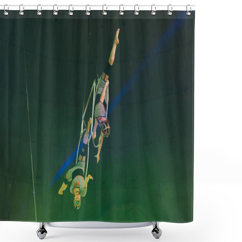 Personality  KYIV, UKRAINE - NOVEMBER 1, 2019: Low Angle View Of Flexible Air Gymnasts Doing Split While Performing With Rings In Circus Shower Curtains