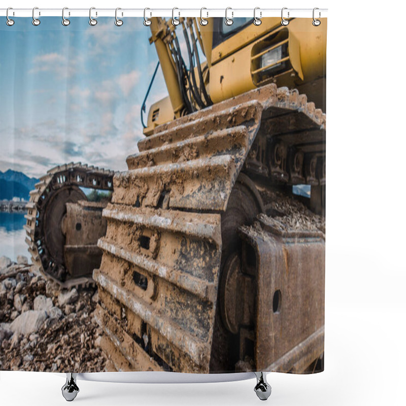 Personality  Mud-Covered Excavator Tracks On A Rocky Construction Site With A Mountain And Water Background Shower Curtains