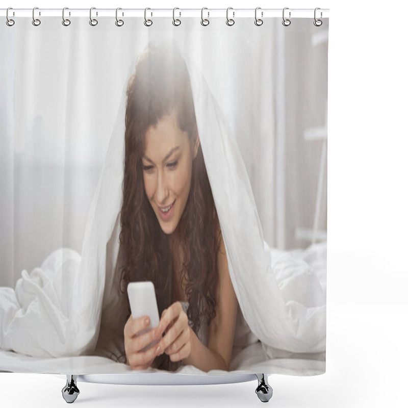 Personality  Happy Young Woman Using Smartphone While Lying Under Blanket  Shower Curtains