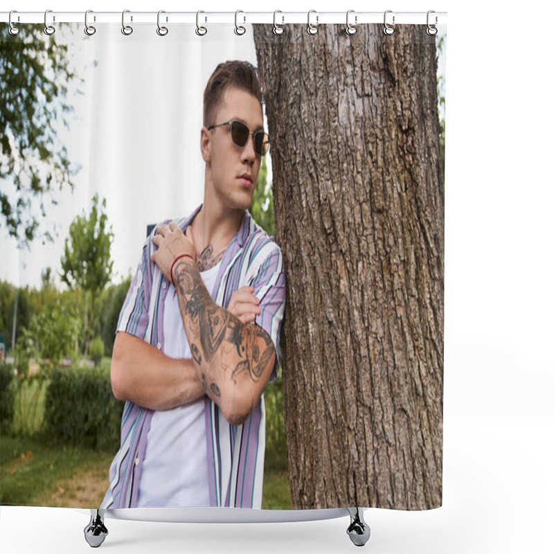 Personality  A Young Man With Tattoos Leans Against A Tree, Showcasing His Tattoos In A Park. Shower Curtains