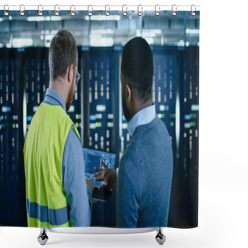 Personality  Back View On Bearded IT Engineer In Glasses And High Visibility Vest With A Laptop Computer And Black Technician Colleague Talking In Data Center While Standing Next To Server Racks. Running Diagnostics Or Maintenance. Shower Curtains