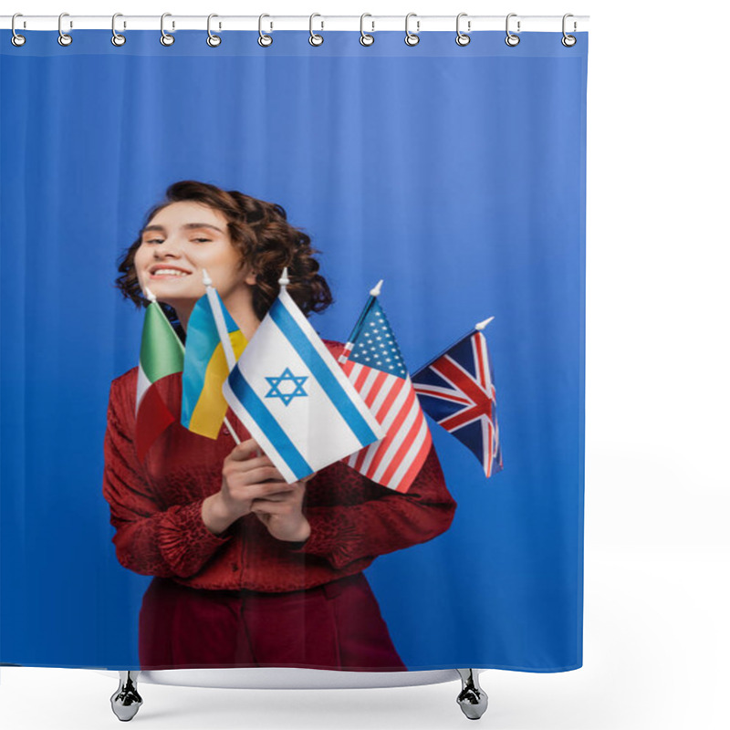 Personality  Young Inspired Woman Looking At Camera While Holding Flags Of Different Countries Isolated On Blue Shower Curtains