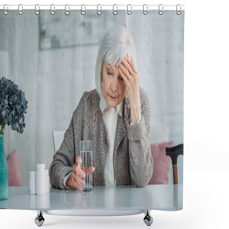 Personality  Portrait Of Grey Hair Woman With Headache Sitting At Table With Pills And Glass Of Water At Home Shower Curtains