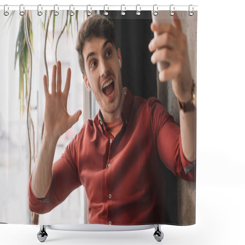 Personality  Man In Wireless Earphones Using Having Video Chat On Smartphone And Waving Hand Near Window Shower Curtains